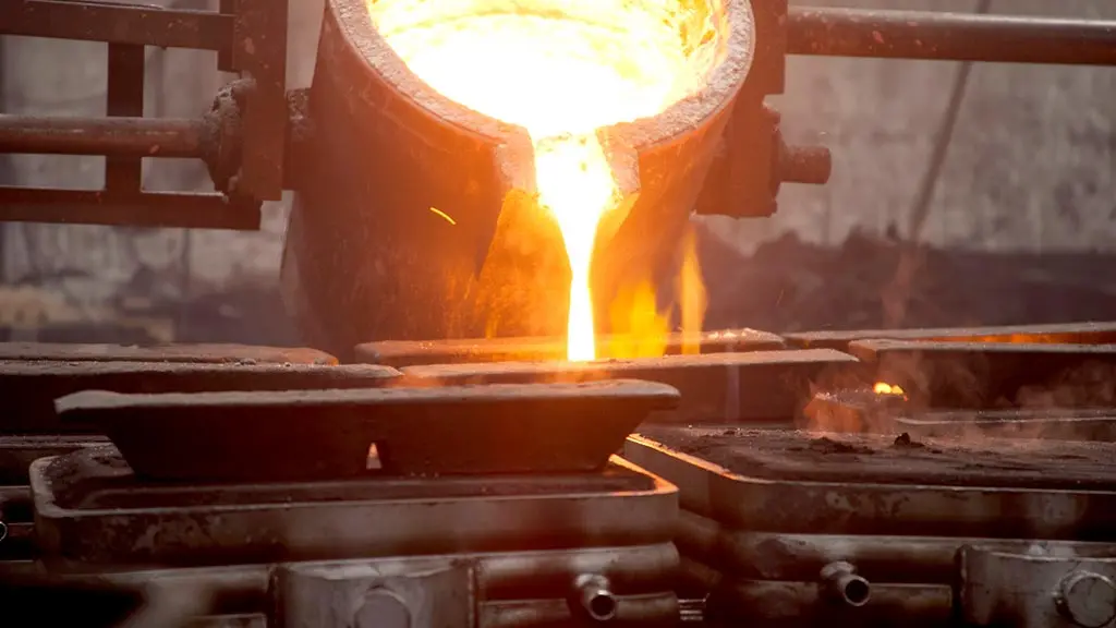 Glowing molten metal poured from a crucible into ingot molds