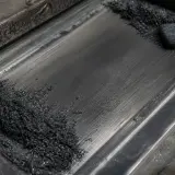 Lubricación seca con polvo de grafito sobre superficie metálica de deslizamiento